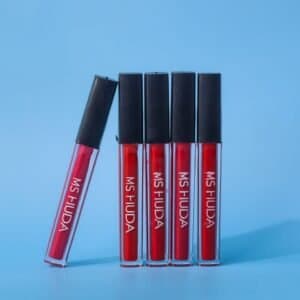 Five red lipstick tubes displayed on a vibrant blue background.