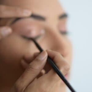 person holding black pen in close up photography